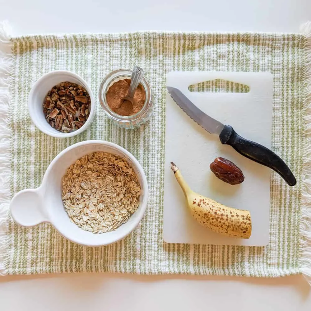 Making Muesli: Oats, pecans, banana, date, and cinnamon. 