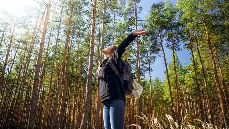 happy woman in a forest
