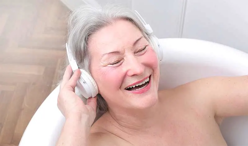 woman in bath listening to music