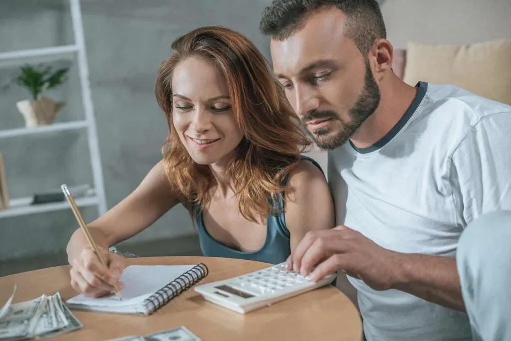 couple calculating their first budget