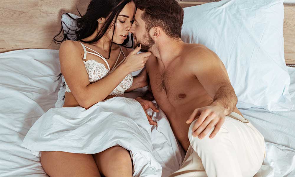 couple in bed kissing