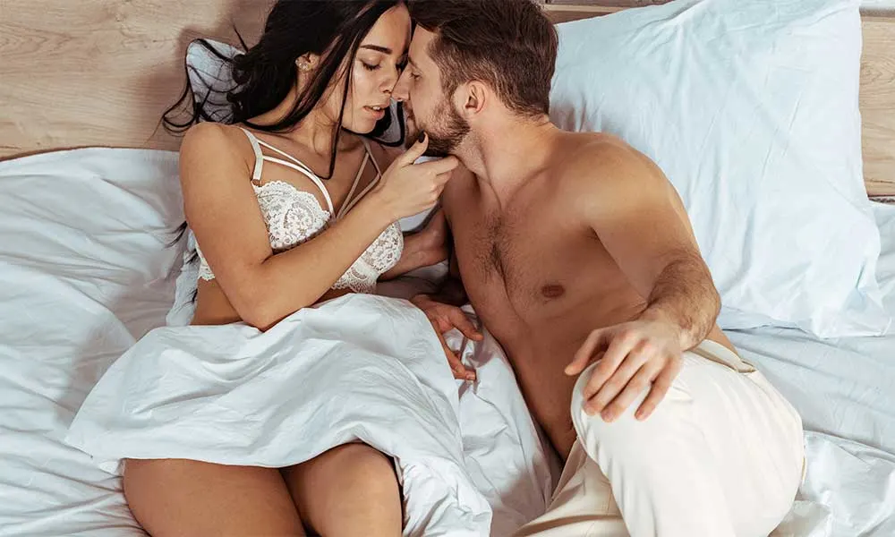 couple in bed kissing