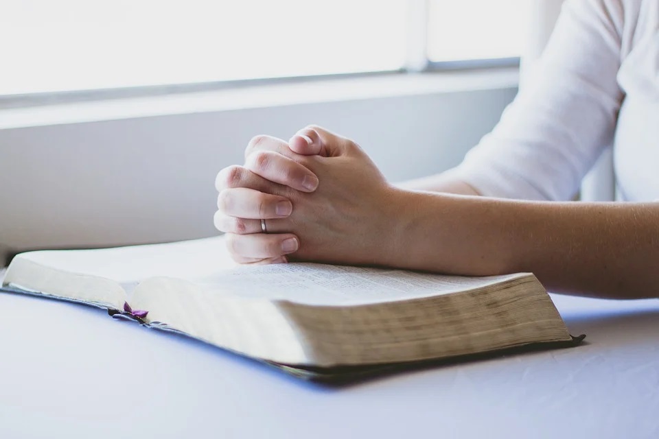 person praying on book