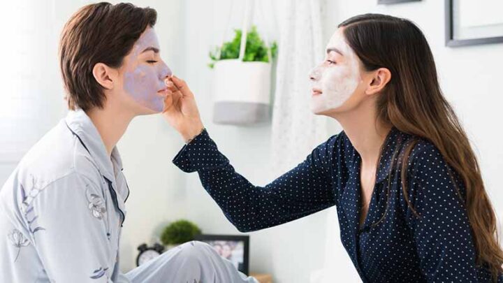 two women doing face masks at home