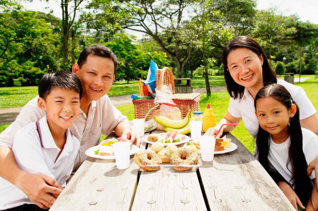 family in all-white outfits at the park