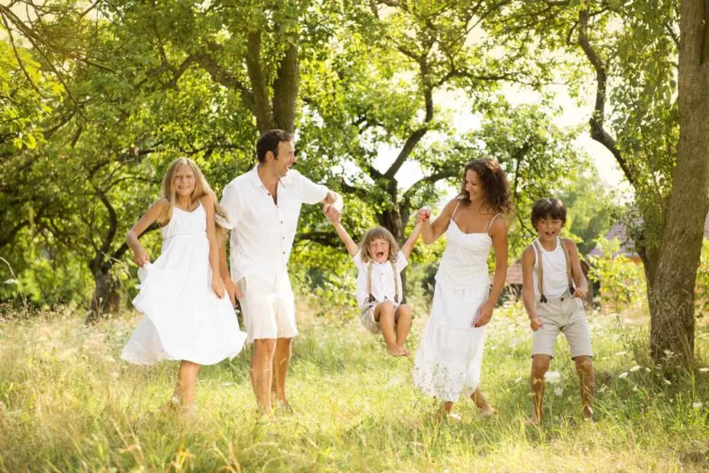 family in all-white outfits in the forest