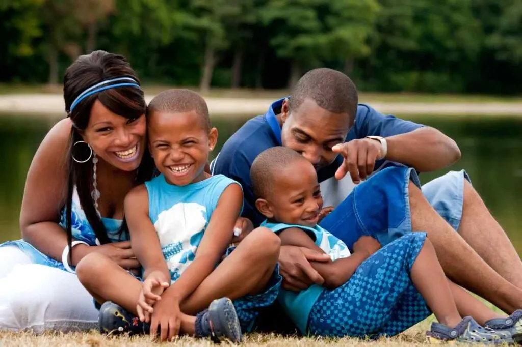 family dressing in blue tones by a lake