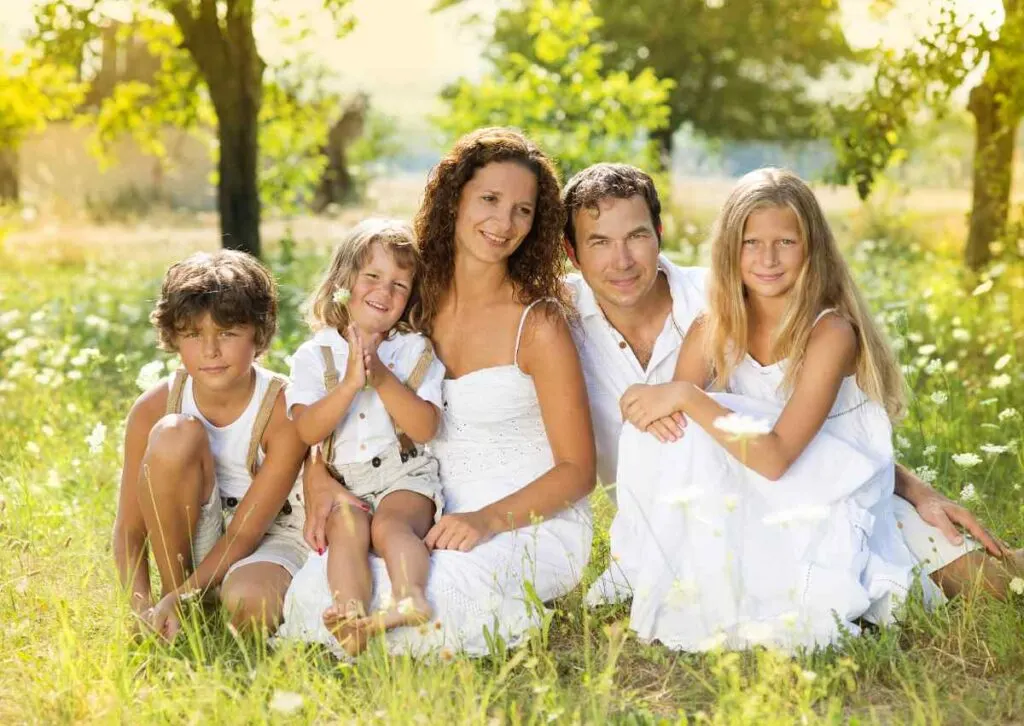 family in all-white outfit in idyllic setting