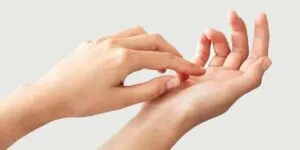 woman scratching right palm hand