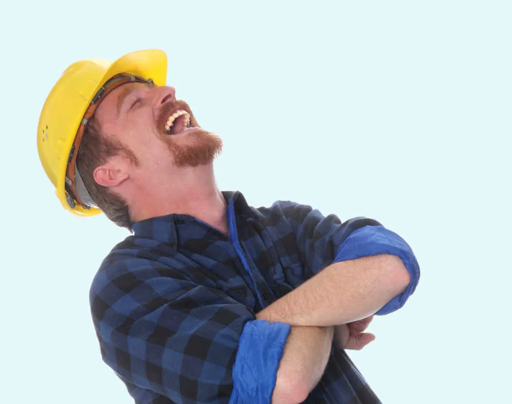 laughing builder with yellow hat on blue background