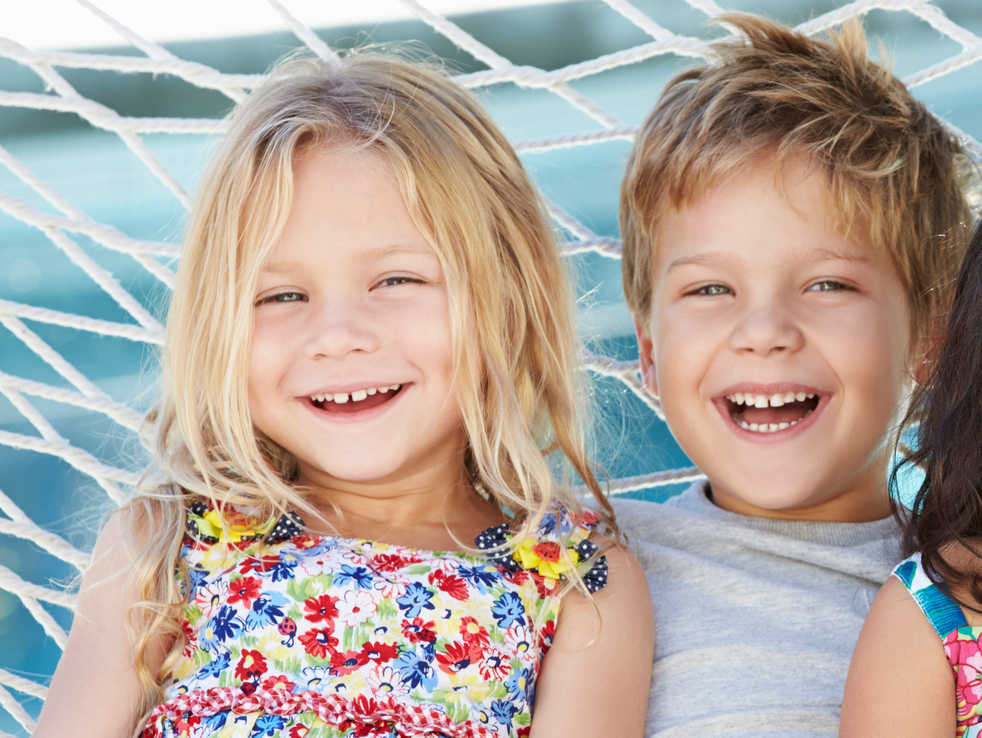 two 5-year old children laughing