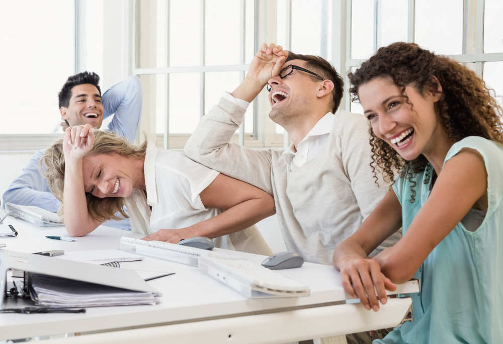 Casual business team laughing during meeting in the office